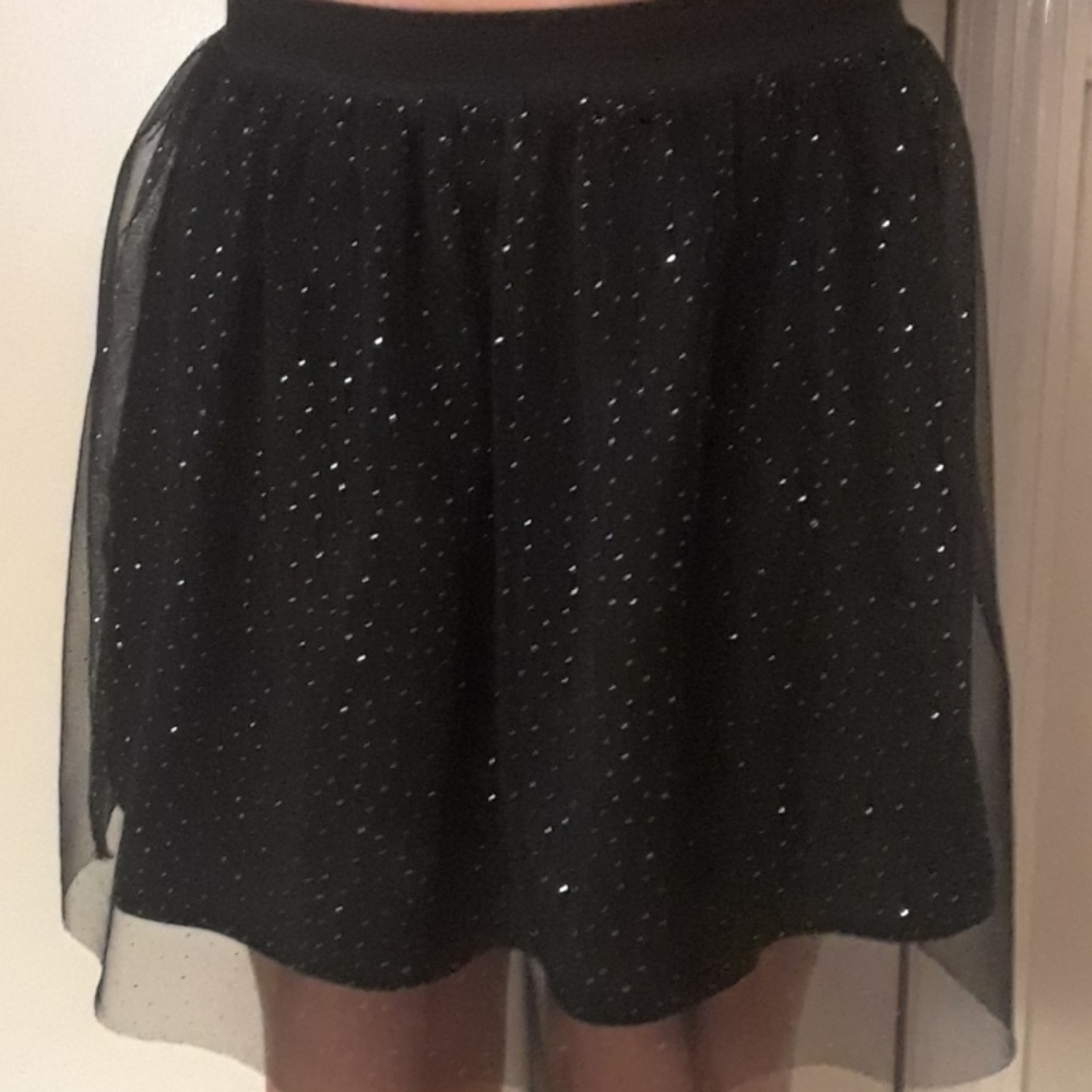 Girls black sparkley mini skirt.